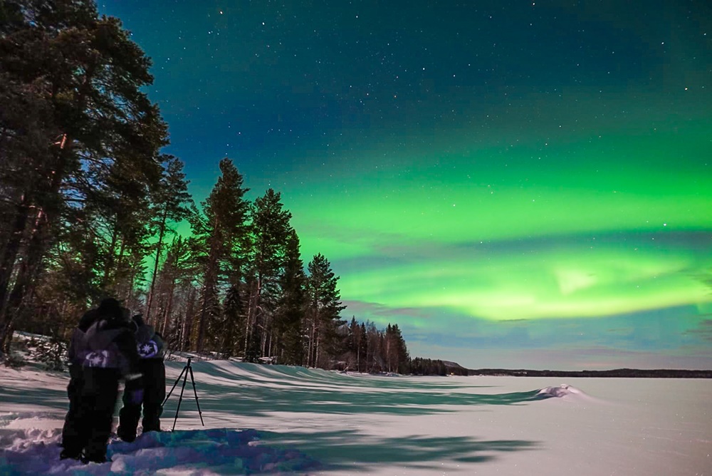 People watching northern lights in Lapland